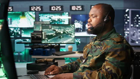 Military-dispatcher-managing-communications-networks,-looking-at-screens