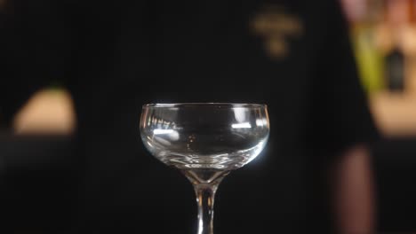 Barman-pouring-beverage-in-a-glass