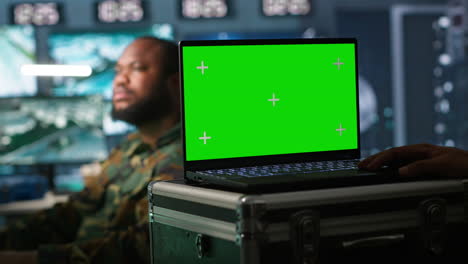 Soldier-using-tracking-software-on-green-screen-laptop-to-gain-info-against-enemies