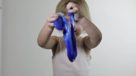 Child-having-fun-making-slime.-Kid-playing-with-hand-made-toy-slime.