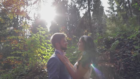 Groom-with-bride-near-mountain-hills-in-the-forest.-Wedding-couple.-Sunbeams