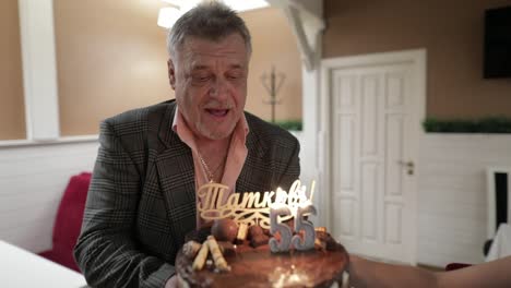 Happy-respectable-old-man-holding-cake.-Celebrating-birthday-anniversary