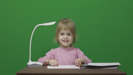 Girl-sitting-at-the-table.-Education-process.-Three-years-old-child.-Chroma-Key