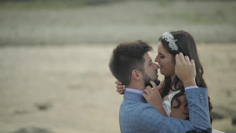 Wedding-couple-standing-near-mountain-river.-Groom-and-bride-in-love