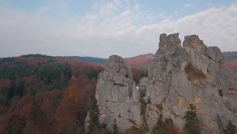 Newlyweds-stand-on-a-high-slope-of-the-mountain.-Groom-and-bride.-Arial-view