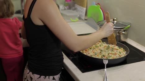 Woman-cooking-fry-meal.-Fig-with-asparagus,-pepper,-corn-and-carrot