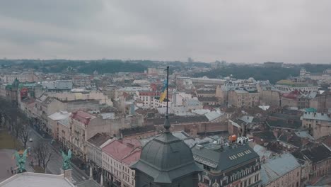 Aerial-Shot-Ukrainian-Flag-Flying-on-Top-of-Lviv-Opera.-European-City.