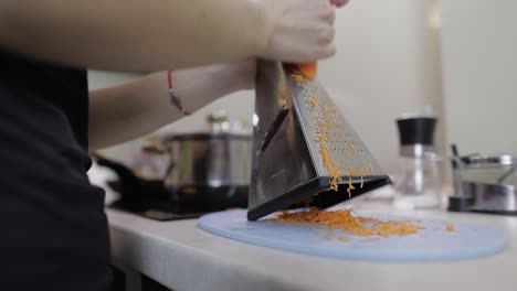 Carrots-on-a-grater-rubbed-on-the-home-kitchen.-Cutting-Carrot-Grater