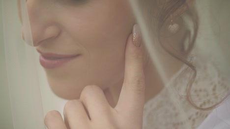 Beautiful-and-lovely-bride-in-night-gown-and-veil-in-the-garden.-Wedding-morning