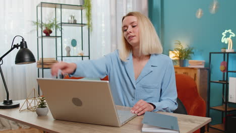 Business-woman-freelancer-taking-break-leaning-on-chair-after-laptop-working-celebrating-success