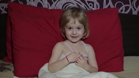 Young-girl-watching-tv-television-on-the-bed