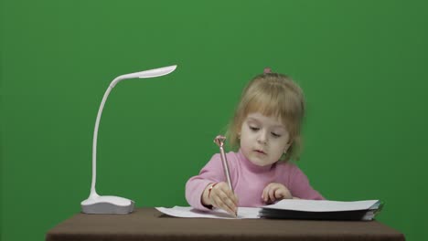 Girl-drawing-at-the-table.-Education-process.-Three-years-old-child.-Chroma-Key