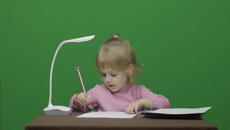 Girl-drawing-at-the-table.-Education-process.-Three-years-old-child.-Chroma-Key