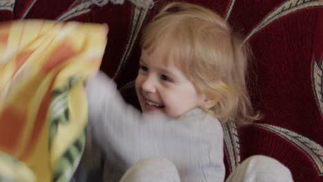 Close-up-of-a-little-blonde-cute-girl-face.-Girl-smiling.-Inside.-Portrait-shot