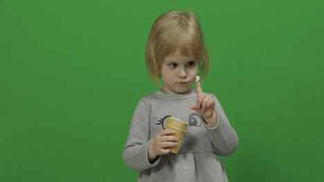 Kid-girl-eat-ice-cream-on-a-Green-Screen,-Chroma-Key