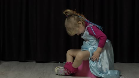 Little-girl-sitting-on-the-potty-and-watching-TV