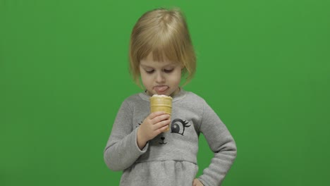 Kid-girl-eat-ice-cream-on-a-Green-Screen,-Chroma-Key