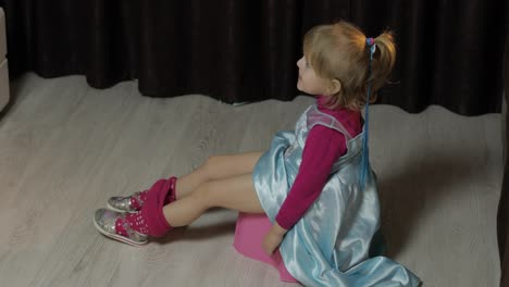 Little-girl-sitting-on-the-potty-and-watching-TV