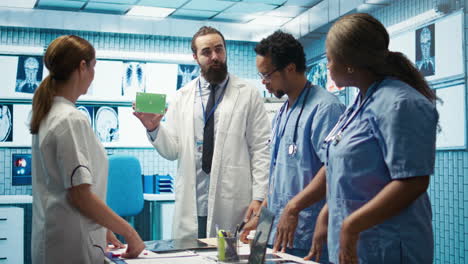 Medical-expert-showing-a-box-with-green-screen-during-a-meeting-for-diagnosis