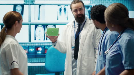 Medical-expert-showing-a-box-with-green-screen-during-a-meeting-for-diagnosis