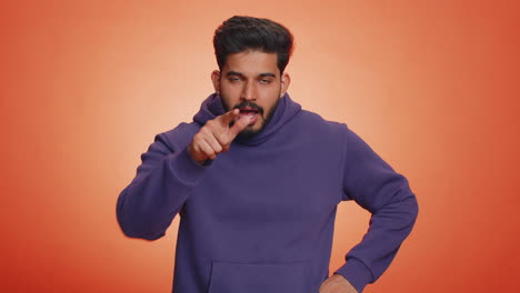 Angry-indian-man-mimicking-knife-with-finger-showing-kill-gesture-of-cutting-throat,-cut-hand-neck