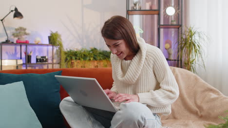 Amazed-young-woman-use-laptop-computer,-receive-good-news-message,-shocked-by-victory,-celebrate-win