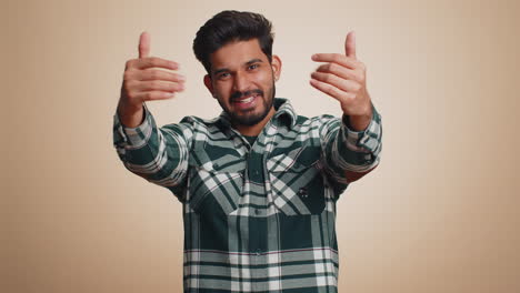 Indian-bearded-man-spread-hands-and-give-hug-embrace-to-you,-pleasant-expression-love-happy-feelings