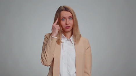 Business-woman-pointing-at-camera-and-showing-stupid-gesture,-blaming-some-idiot-for-insane-plan