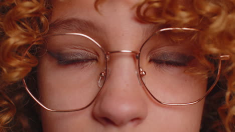 Close-up-macro-portrait-of-teen-child-kid-face-smiling,-brown-girl-eyes-looking-at-camera-blink-wink