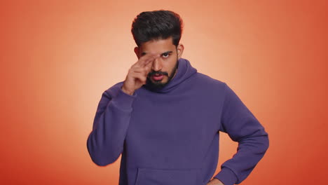 Indian-man-pointing-at-his-eyes-and-camera-show-I-am-watching-you-gesture-spying-watching-on-someone