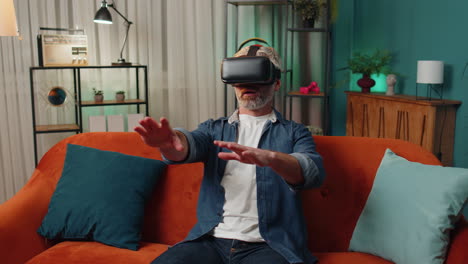 Man-using-virtual-reality-futuristic-technology-headset-to-play-simulation-3D-video-game-at-home