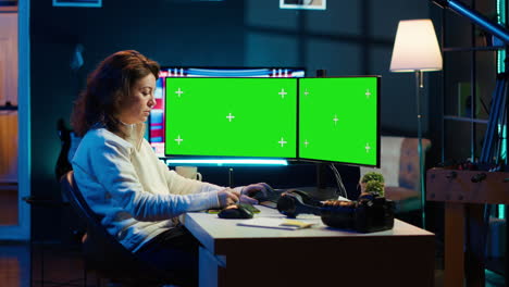 Photographer-using-photo-editing-software-on-chroma-key-multi-monitors-setup