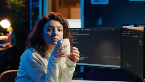 Portrait-of-smiling-IT-specialist-drinking-coffee,-writing-code