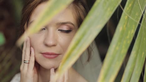 Face-of-beautiful-and-lovely-bride-in-wedding-dress-in-the-park.-Slow-motion