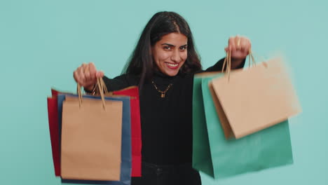 Indian-woman-show-shopping-bags,-advertising-discounts-amazed-with-low-prices-Black-Friday-holidays