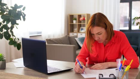 Vertical-Freelance-Work-Woman-Laptop-Couch-Home.Vertical-video.-Freelance-work.-Modern-technology.-Smiling-woman-in-casual-cloth-sitting-with-laptop-on-comfortable-couch-in-light-living-room-interior-at-home.