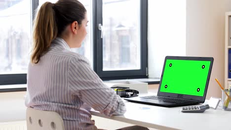 Young-woman-having-talk-video-call-on-laptop-computer-at-home..Handheld-low-angle-view-shot,-Female-freelancer-explaining-project-in-online-meeting-with-team-members-via-laptop-in-home-office.-Working-from-home,-Remote-working.