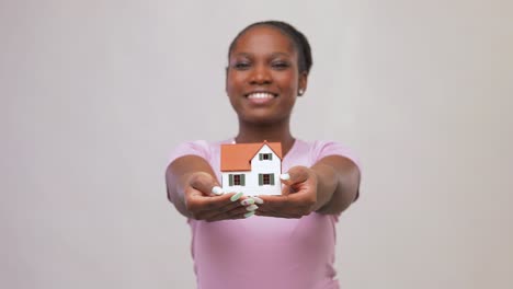 Woman-Posing-House-Door-Vertical-Closeup-Smiling-African-American-Holding-Keys.Woman-posing-house-door-vertical-closeup.-Smiling-african-american-holding-keys-looking-camera.-Attractive-black-hair-real-estate-agent-wait-client-at-luxurious-mansion.-Wealthy-businesswoman-realtor.