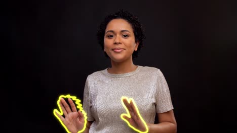 Woman-Dancing-with-Glowing-Lines-in-Shape-of-Fire.leisure-and-people-concept--happy-african-american-woman-dancing-over-black-background-with-animated-glowing-neon-lines-in-shape-of-fire