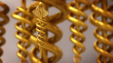 The-golden-shining-Rod-of-Asclepius,-which-is-the-symbol-of-healthcare-and-medical-practice.-Two-serpents-around-the-spike-with-wings-symbolizing-the-certain-medical-knowledge.-Loopable-3D-sign.-HD