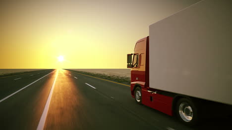 Animation-of-a-truck-on-the-road-with-the-clear-sunsetting-sky-background.-A-large-delivery-truck-is-moving-forward.-Cargo-delivery.-Lorry-with-a-huge-capacity-trailer.-Overall-side-view.-HD