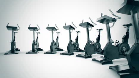 Animation-of-modern-gym-equipment-stationary-bikes-standing-in-a-circle.-Indoor-cycling-activity-machines-helping-to-stay-fitness-even-if-the-weather-outside-is-not-good-for-a-ride.-Loopable.-HD