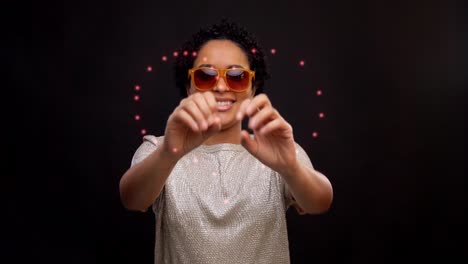 Woman-in-Sunglasses-Dancing-with-Glowing-Lines.leisure-and-people-concept--happy-african-american-woman-in-sunglasses-dancing-over-black-background-with-animated-glowing-neon-lines