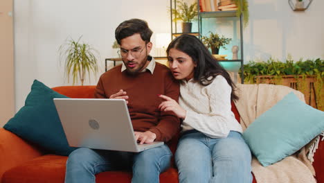 Shocked-disappointed-young-Indian-family-couple-using-laptop-reading-bad-unlucky-news-fail-lose