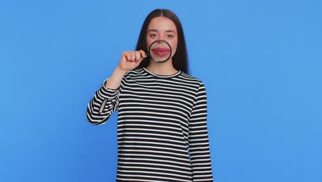 Happy-smiling-young-woman-holding-magnifier-glass-on-teeth-health-care-hygiene-stomatology-concept