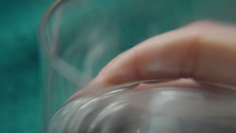 Female-hand-touches-water-glass-nervously