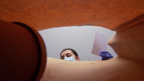 Mujer-Con-Guantes-Y-Mascarilla-Sacando-Comida-De-Una-Bolsa.-Protección-De-La-Salud,-Entrega-A-Domicilio-Y-Concepto-De-Pandemia.-Mujer-Con-Guantes-Médicos-Protectores-Y-Mascarilla-Sacando-Comida-China-Para-Llevar-De-Una-Bolsa-De-Papel.