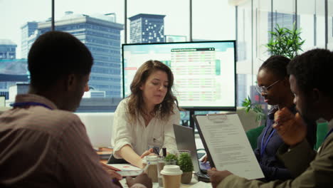 Financial-expert-showing-statistics-data-on-papers-in-a-conference-room