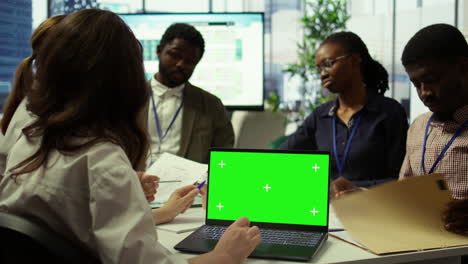 Diverse-team-of-business-associates-looking-at-mockup-chroma-key-screen