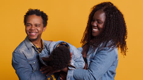 Portrait-of-african-american-family-with-a-little-child-posing-on-camera